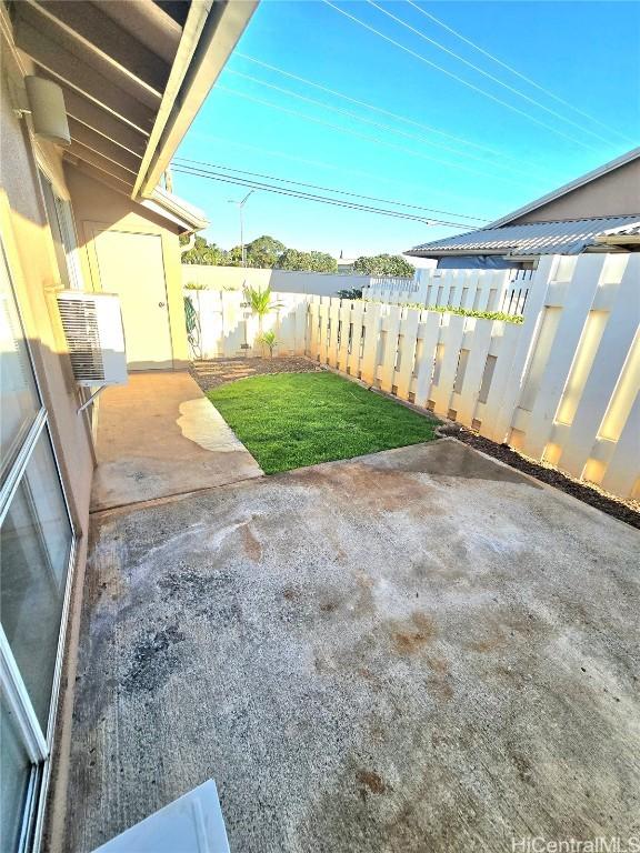 view of yard with cooling unit and a patio area