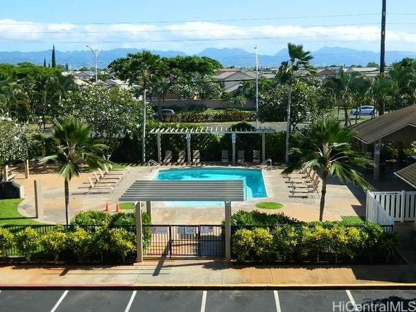 view of swimming pool with a mountain view