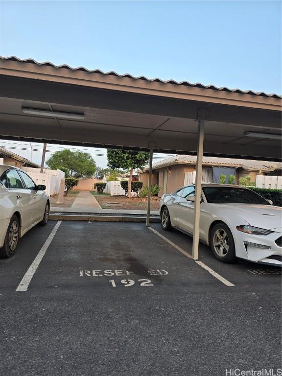 view of parking / parking lot featuring a carport