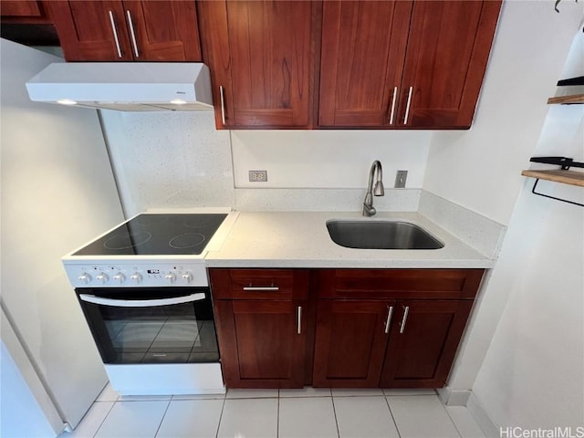 kitchen with sink, stainless steel range with electric cooktop, light stone counters, light tile patterned floors, and range hood