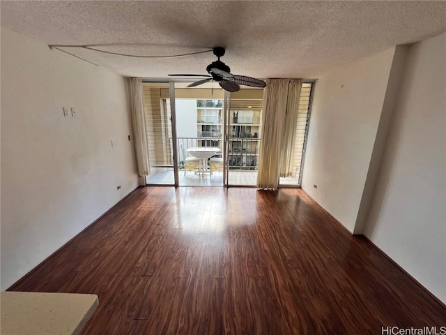 spare room featuring ceiling fan, floor to ceiling windows, hardwood / wood-style floors, and a textured ceiling