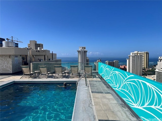 view of swimming pool with a water view