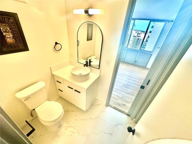 bathroom featuring vanity and toilet