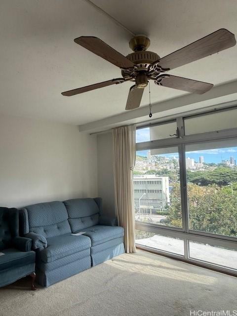 living room with ceiling fan and carpet floors