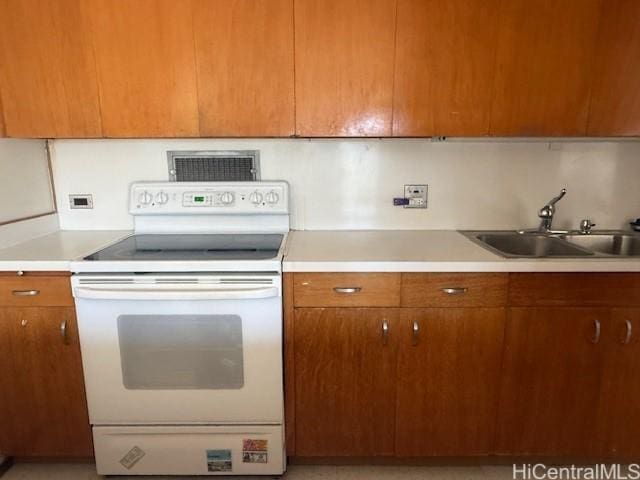 kitchen featuring white range with electric cooktop and sink