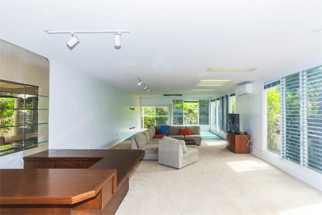 living room featuring a textured ceiling, an AC wall unit, and light carpet