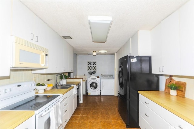 kitchen with washer and clothes dryer, white cabinets, white appliances, and a textured ceiling