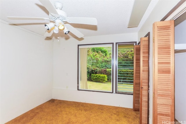 carpeted empty room with ceiling fan