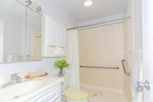 bathroom with curtained shower, vanity, and toilet