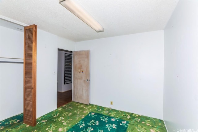 unfurnished bedroom featuring a closet and a textured ceiling