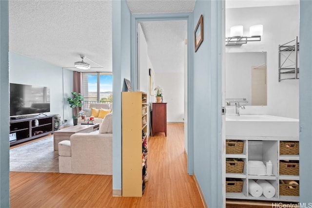 interior space with hardwood / wood-style floors, a wall of windows, and a textured ceiling