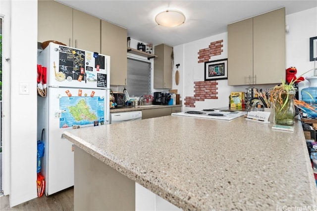 kitchen featuring dark hardwood / wood-style flooring, white appliances, and cream cabinetry