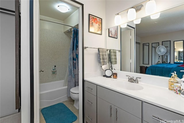 bathroom with tile patterned flooring, toilet, vanity, shower / bath combo, and ensuite bath