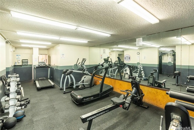 exercise room with a textured ceiling