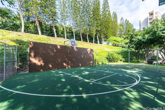 view of basketball court with community basketball court and fence