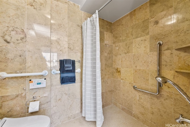 bathroom featuring toilet and a shower with shower curtain