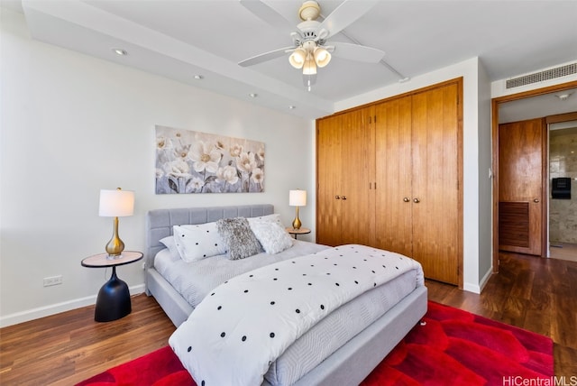 bedroom featuring ceiling fan, a closet, and dark hardwood / wood-style floors