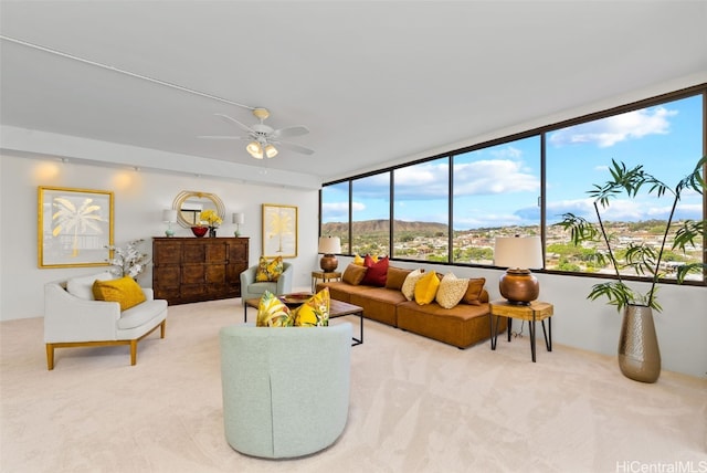 carpeted living room with ceiling fan