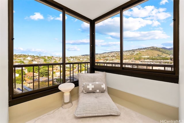 sunroom / solarium featuring a mountain view and plenty of natural light