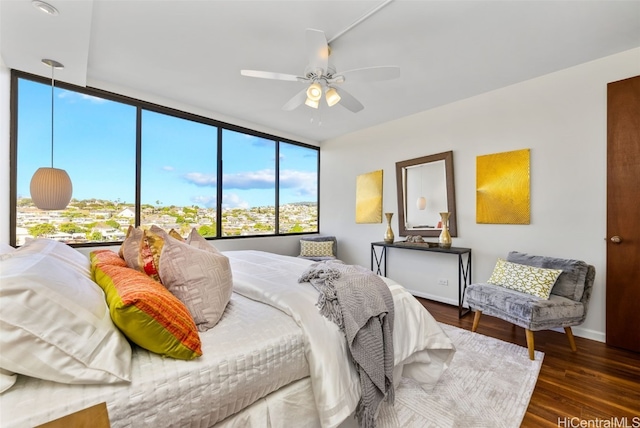 bedroom featuring ceiling fan and dark wood-type flooring