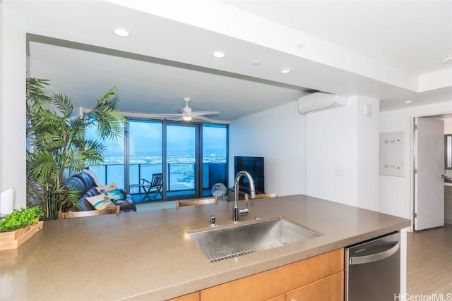 kitchen with stainless steel dishwasher, floor to ceiling windows, a wall unit AC, ceiling fan, and sink