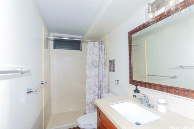 bathroom featuring walk in shower, vanity, and toilet