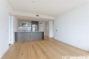 unfurnished living room with light wood-type flooring