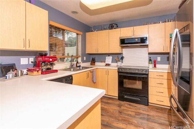 kitchen with light brown cabinets, sink, kitchen peninsula, and stainless steel appliances