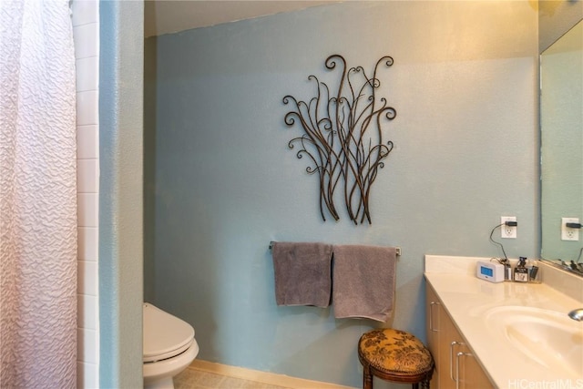 bathroom with tile patterned floors, vanity, and toilet