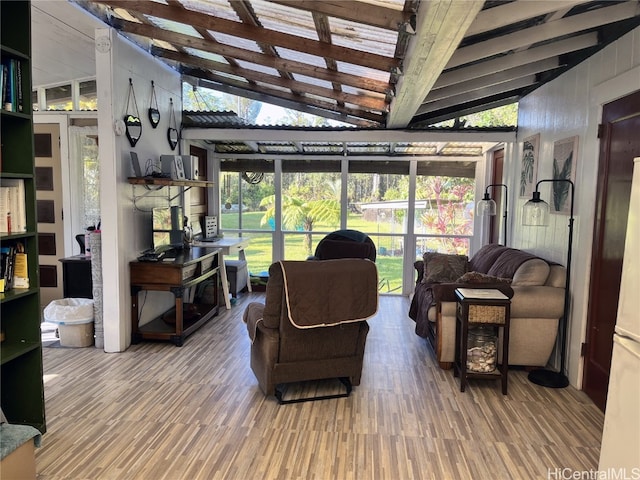 living room featuring lofted ceiling with beams and hardwood / wood-style flooring