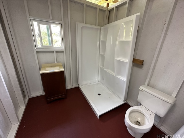 bathroom featuring toilet and walk in shower