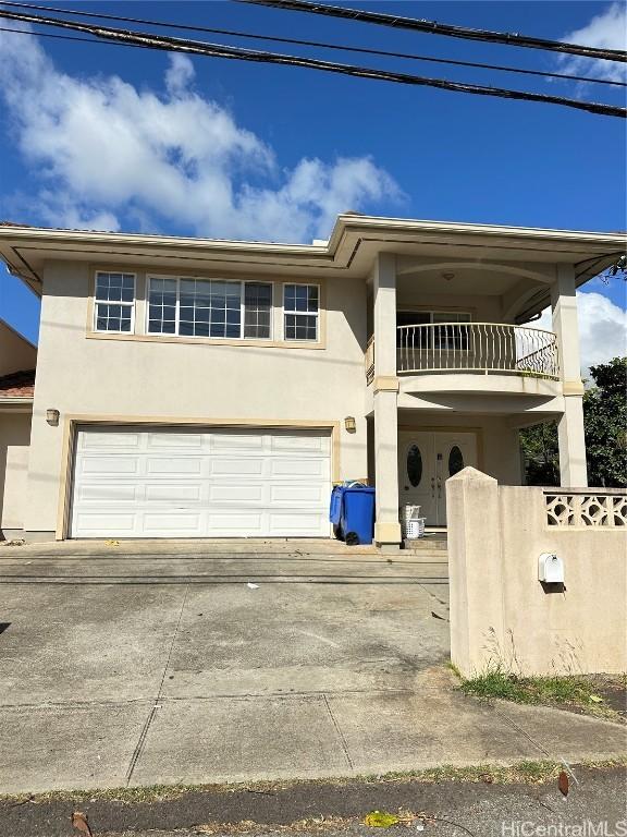 view of front of property with a balcony and a garage