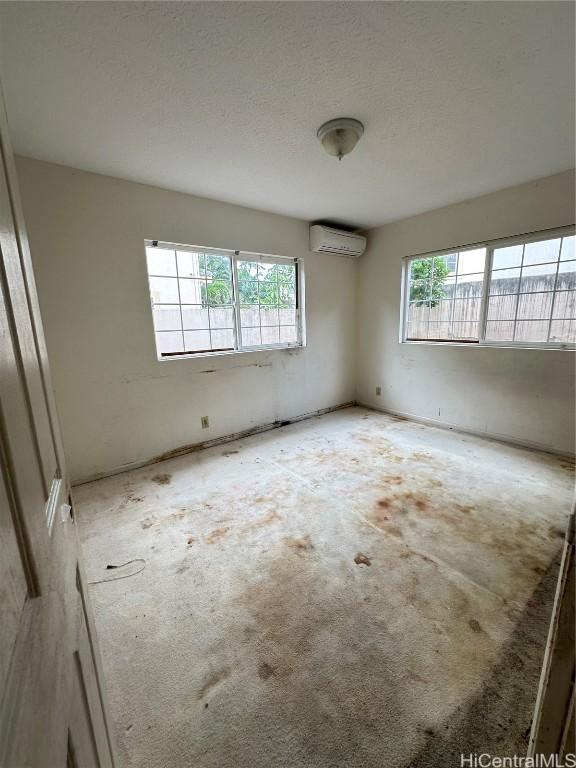 spare room featuring a wall unit AC