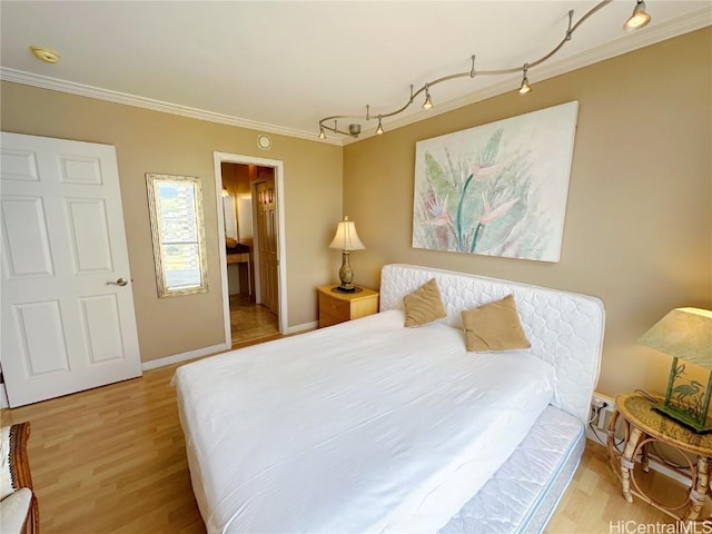 bedroom featuring light wood-type flooring and ornamental molding