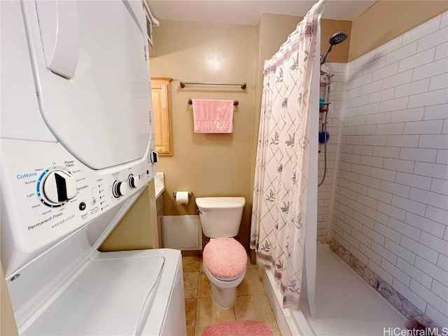 bathroom featuring toilet, vanity, stacked washer and clothes dryer, and curtained shower