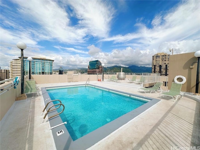 view of swimming pool featuring a mountain view and a patio