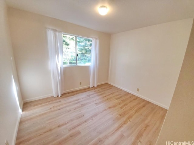 empty room with light hardwood / wood-style flooring