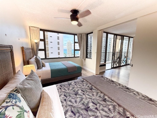 bedroom featuring ceiling fan, a textured ceiling, and hardwood / wood-style flooring