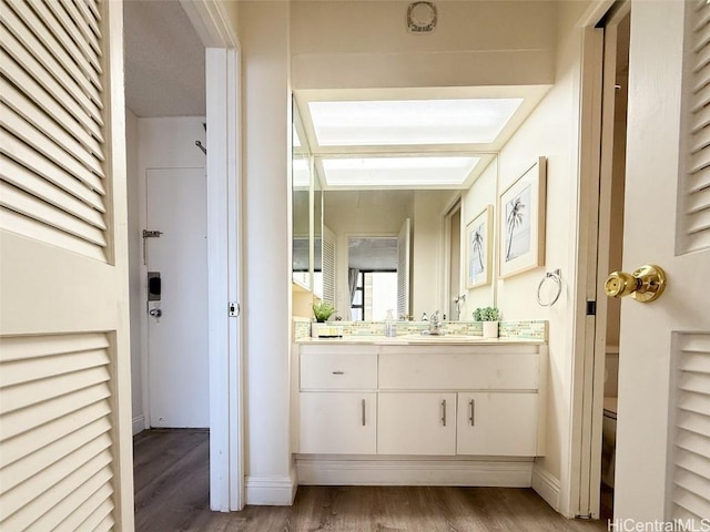 bathroom featuring hardwood / wood-style floors, vanity, and toilet