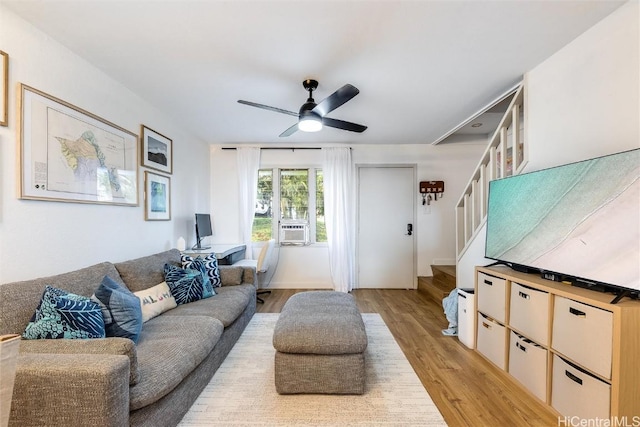 living room featuring light wood-type flooring, ceiling fan, and cooling unit