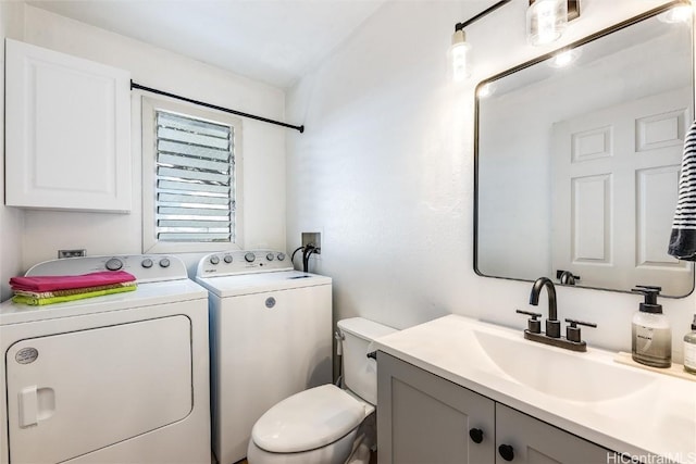 bathroom featuring washer and dryer, vanity, and toilet