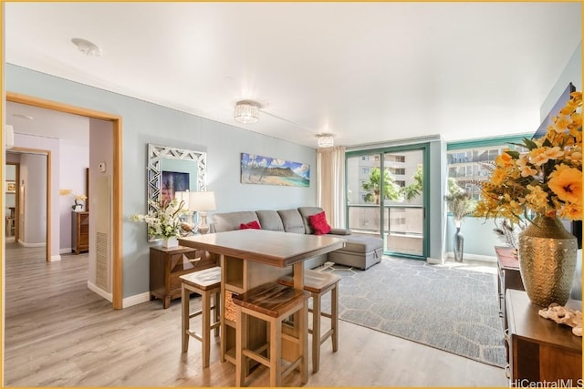 dining space with light hardwood / wood-style flooring