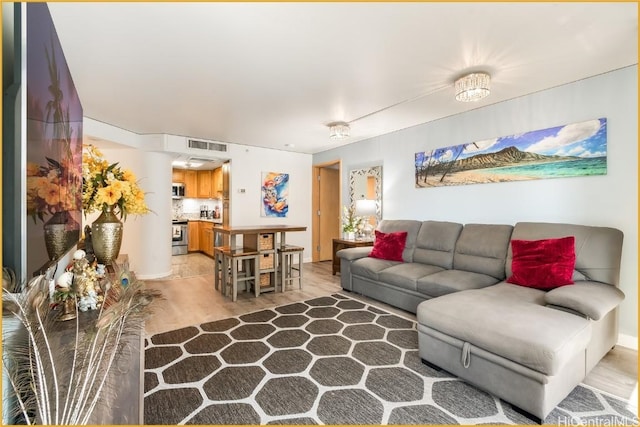 living room with light hardwood / wood-style flooring