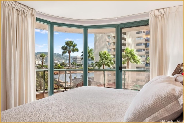 bedroom featuring access to exterior and a water view