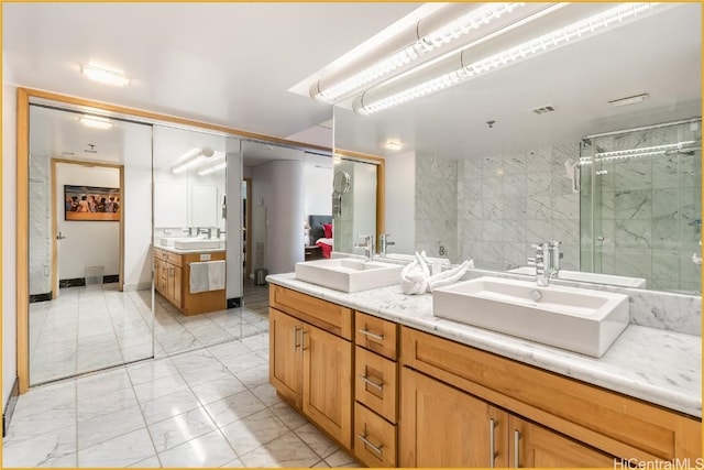 bathroom featuring vanity and a shower with door