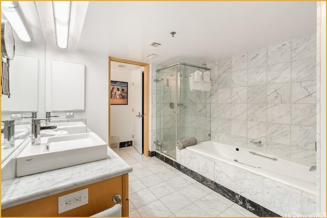 bathroom with vanity and shower with separate bathtub