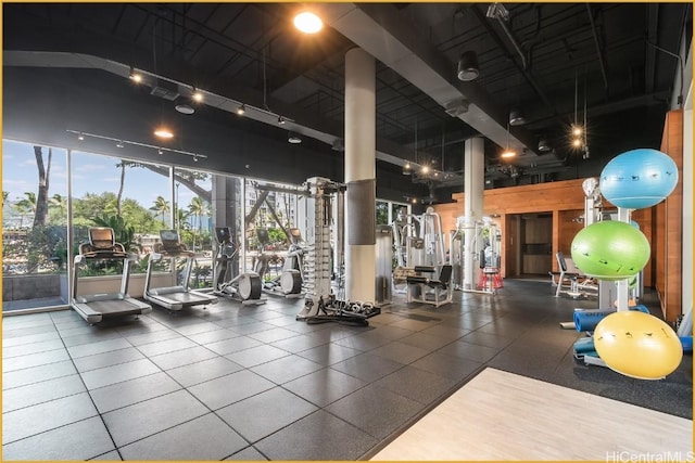 gym with a wall of windows