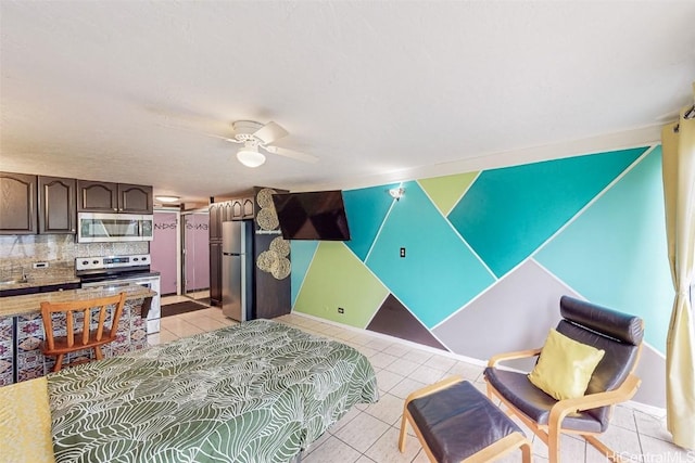 tiled bedroom with stainless steel refrigerator and ceiling fan