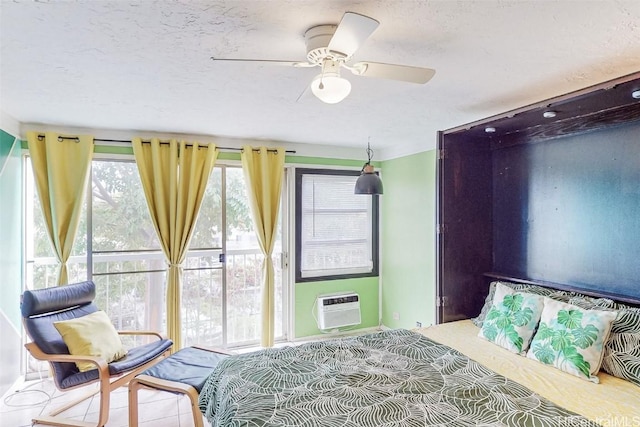 bedroom featuring a textured ceiling, an AC wall unit, and ceiling fan