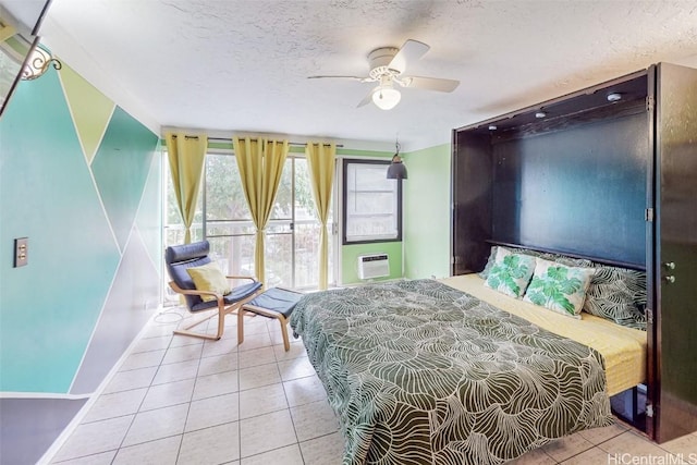 bedroom featuring a textured ceiling, a wall unit AC, ceiling fan, and light tile patterned flooring